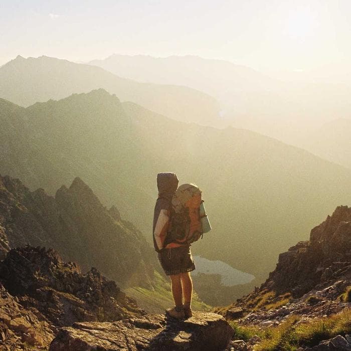 Hiker overlooking a misty mountain range
