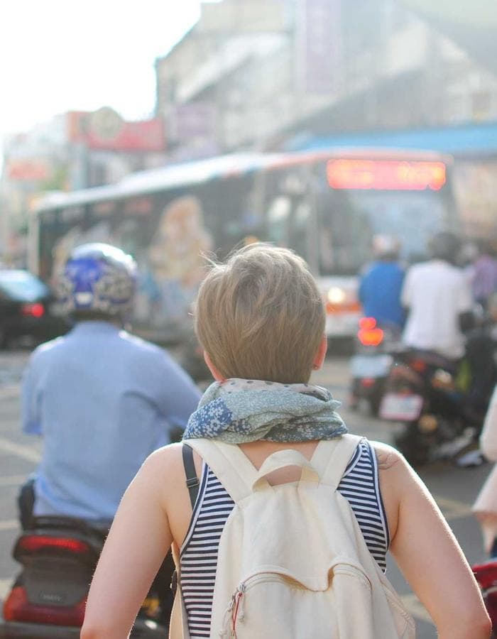 Traveler with a backpack walking through a busy street
